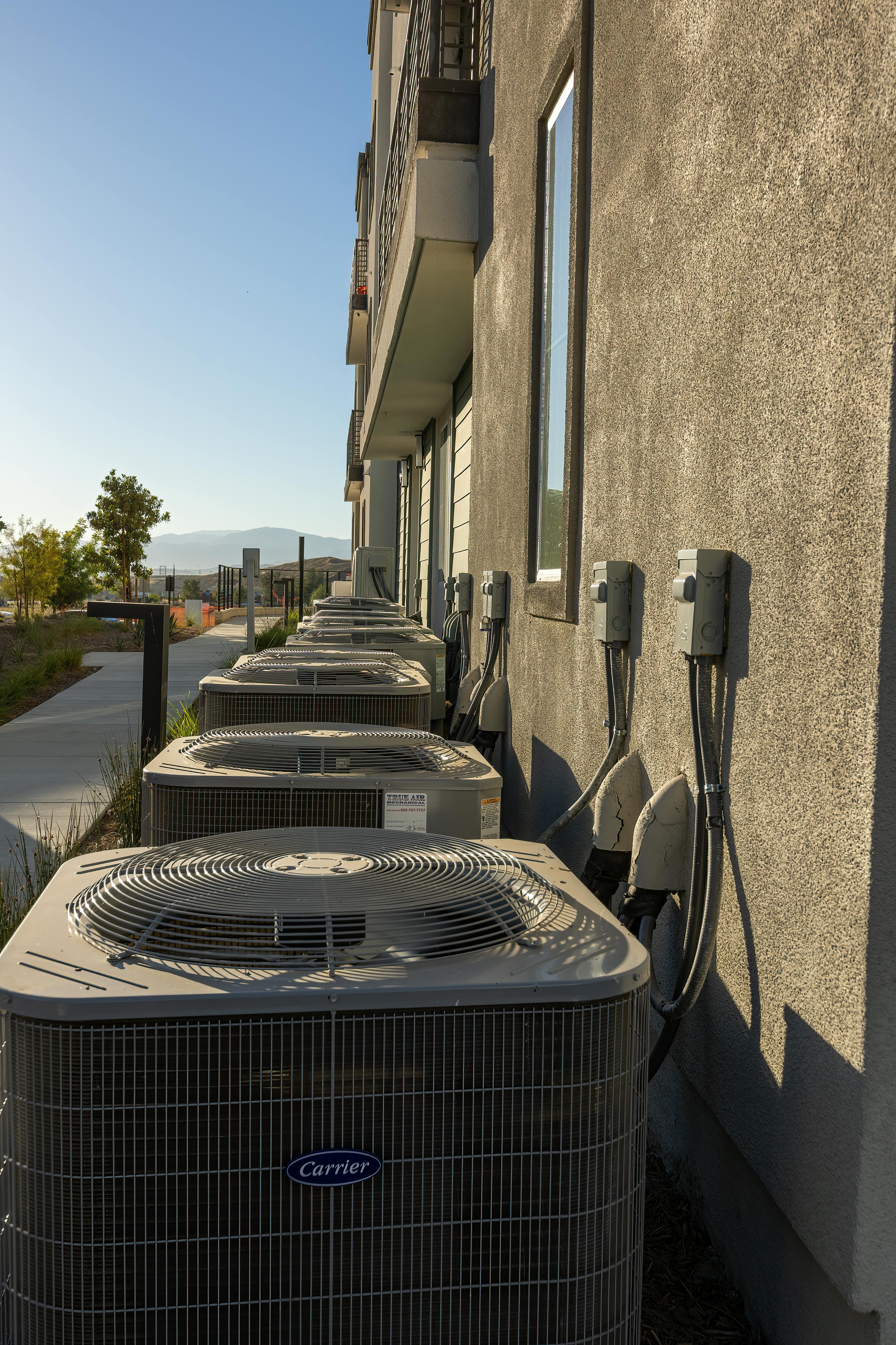 A clean row of new Carrier units along an exterior wall