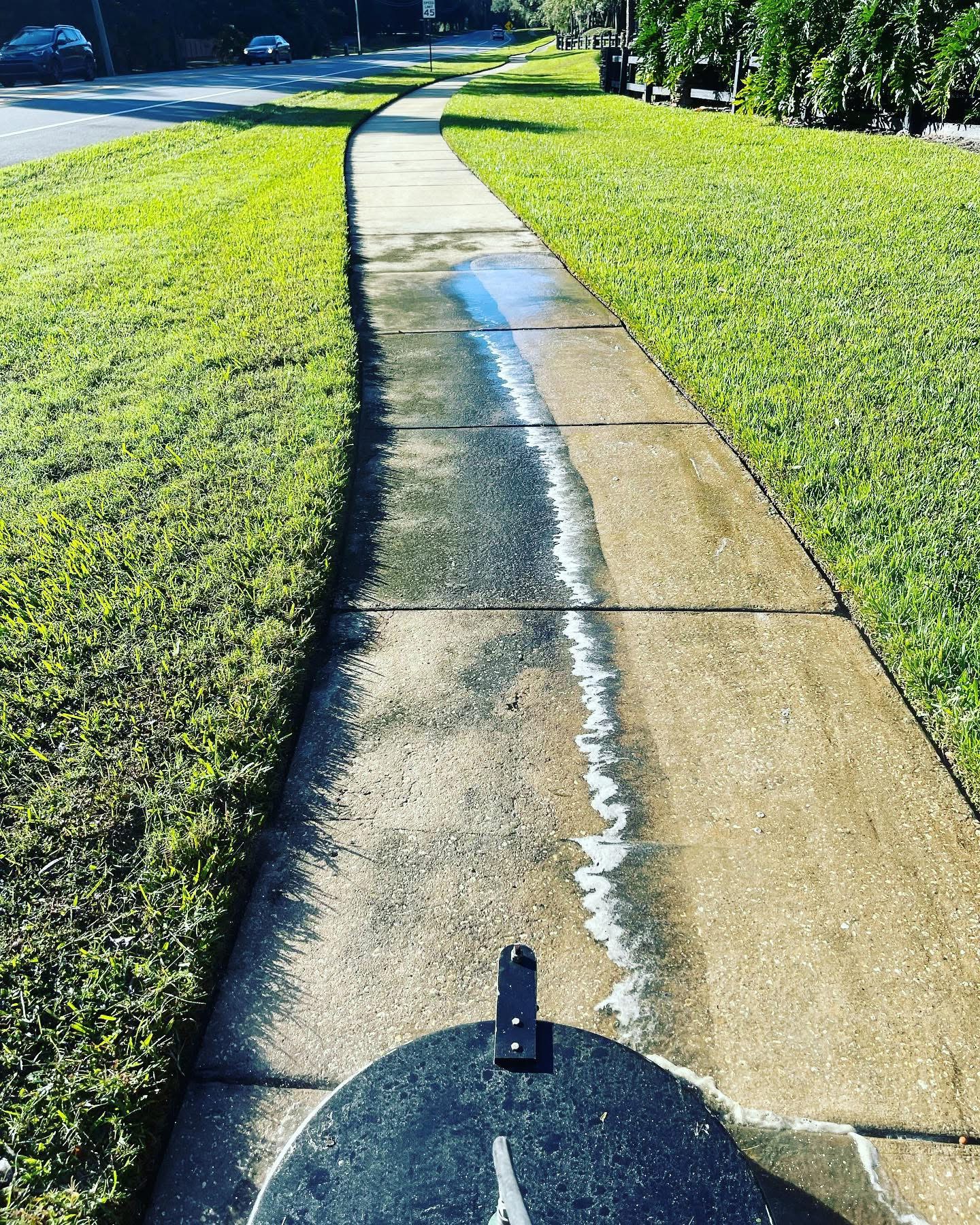 Sidewalk cleaning mid-pass showing dramatic difference