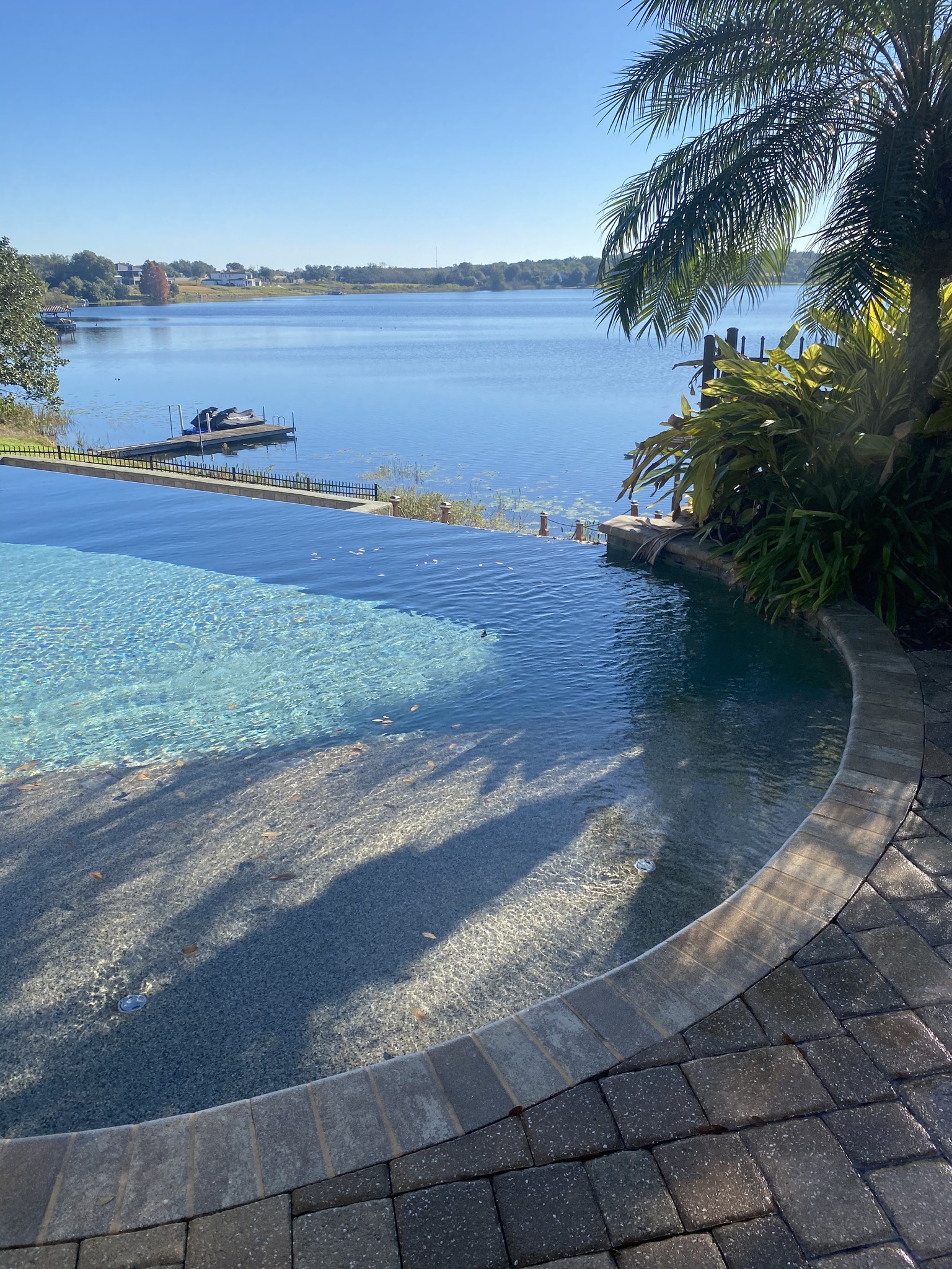 Clean pool deck overlooking a Florida lake